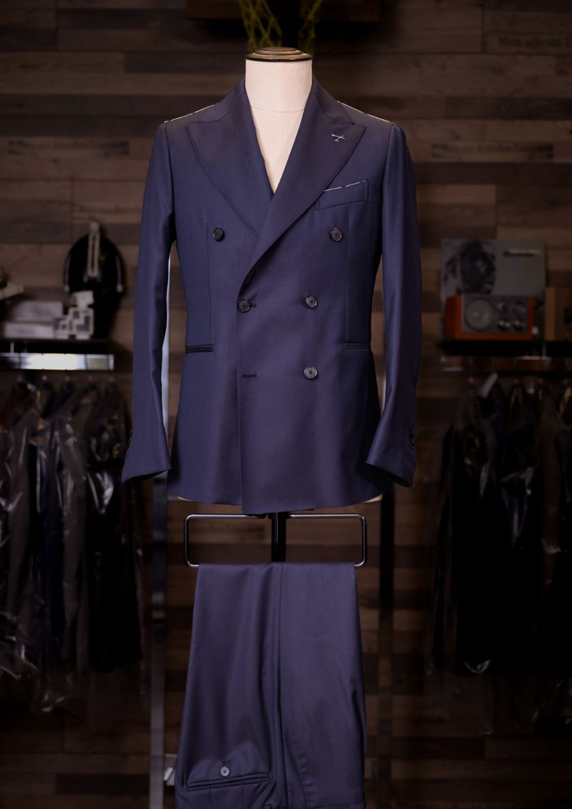 Midnight navy double-breasted Carelli suit on a tailor's mannequin