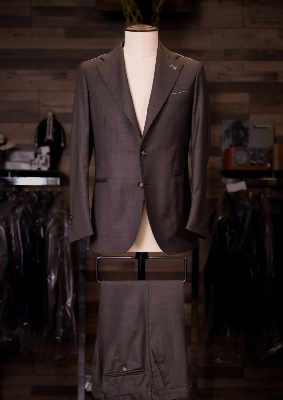 Cocoa brown single-breasted Carelli suit on a tailor's mannequin