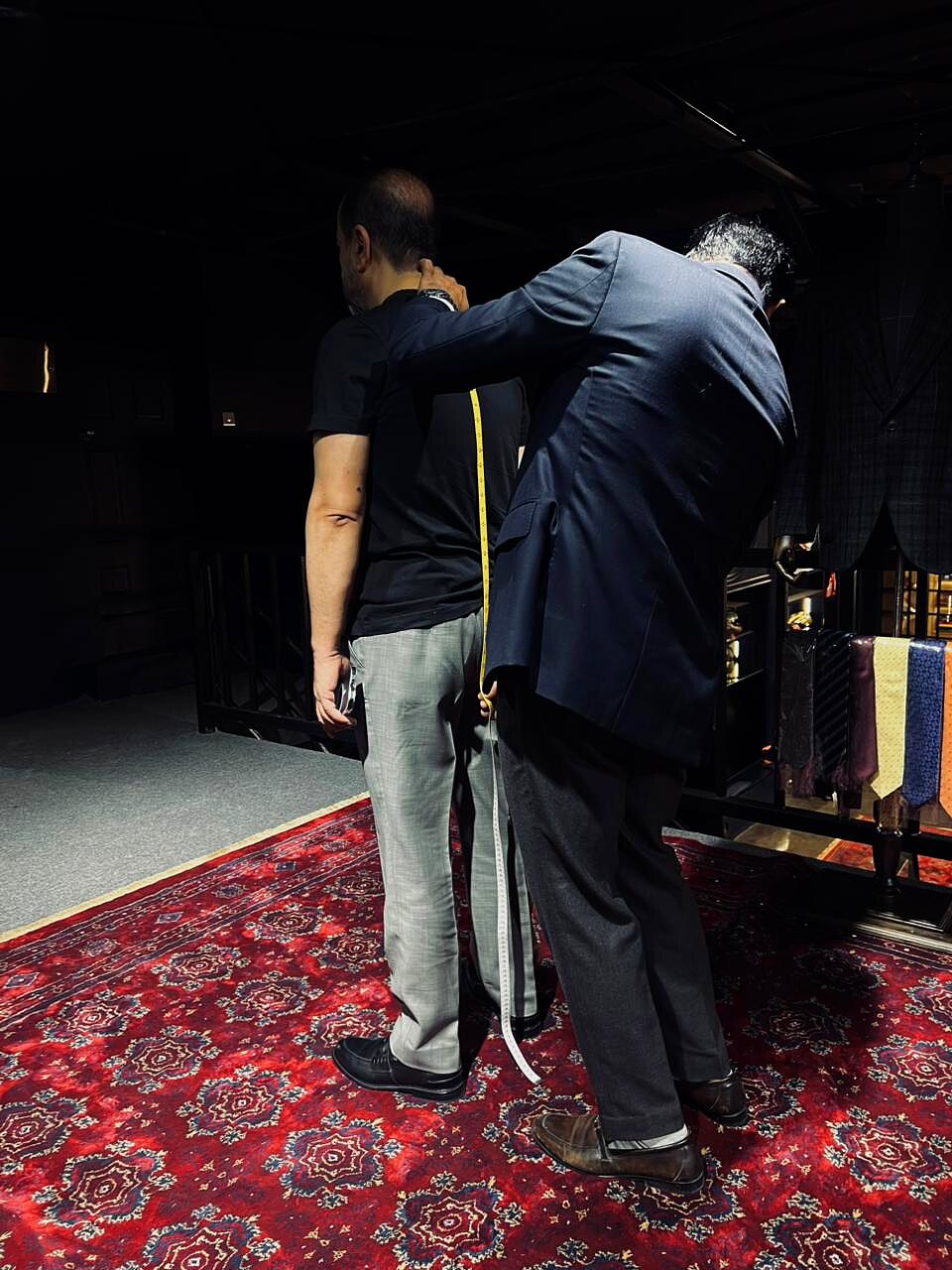 Tailor measuring waist suppression on a client