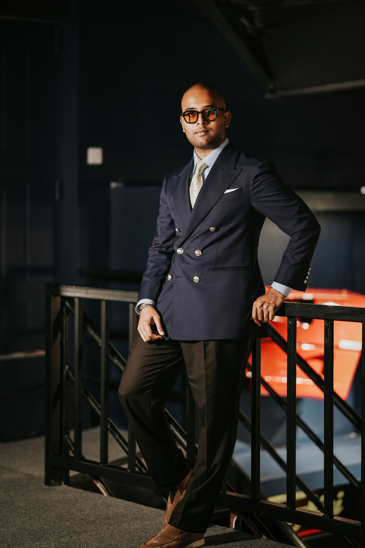 Client in a navy double-breasted blazer with gold buttons