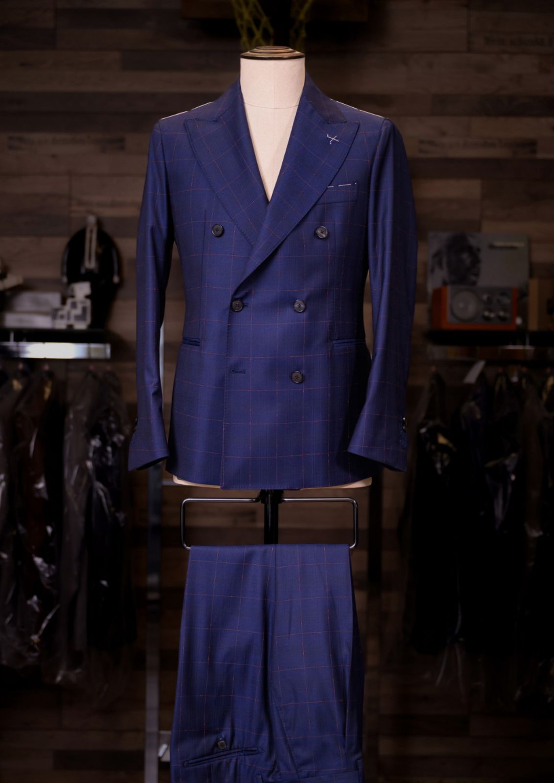 Navy windowpane double-breasted Carelli suit on a tailor's mannequin