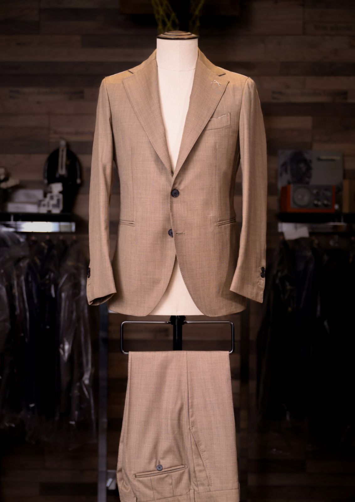 Camel single-breasted Carelli suit on a tailor's mannequin