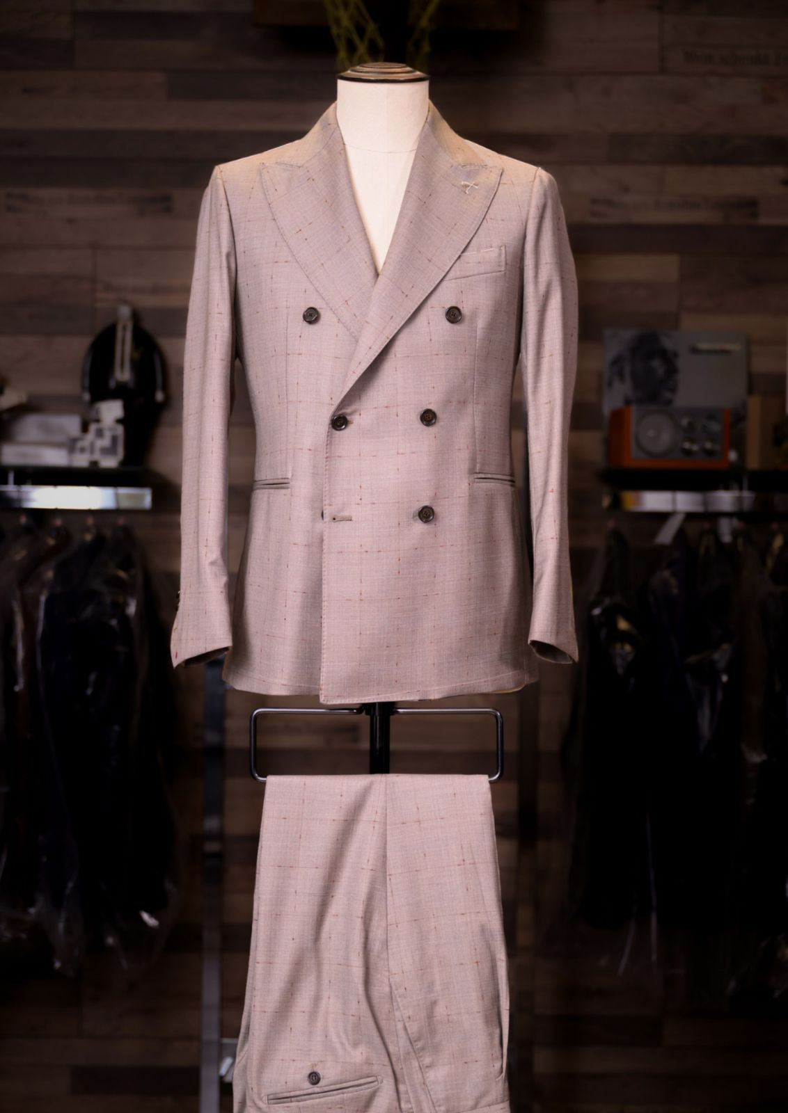 Stone oat fleck double-breasted Carelli suit on a tailor's mannequin