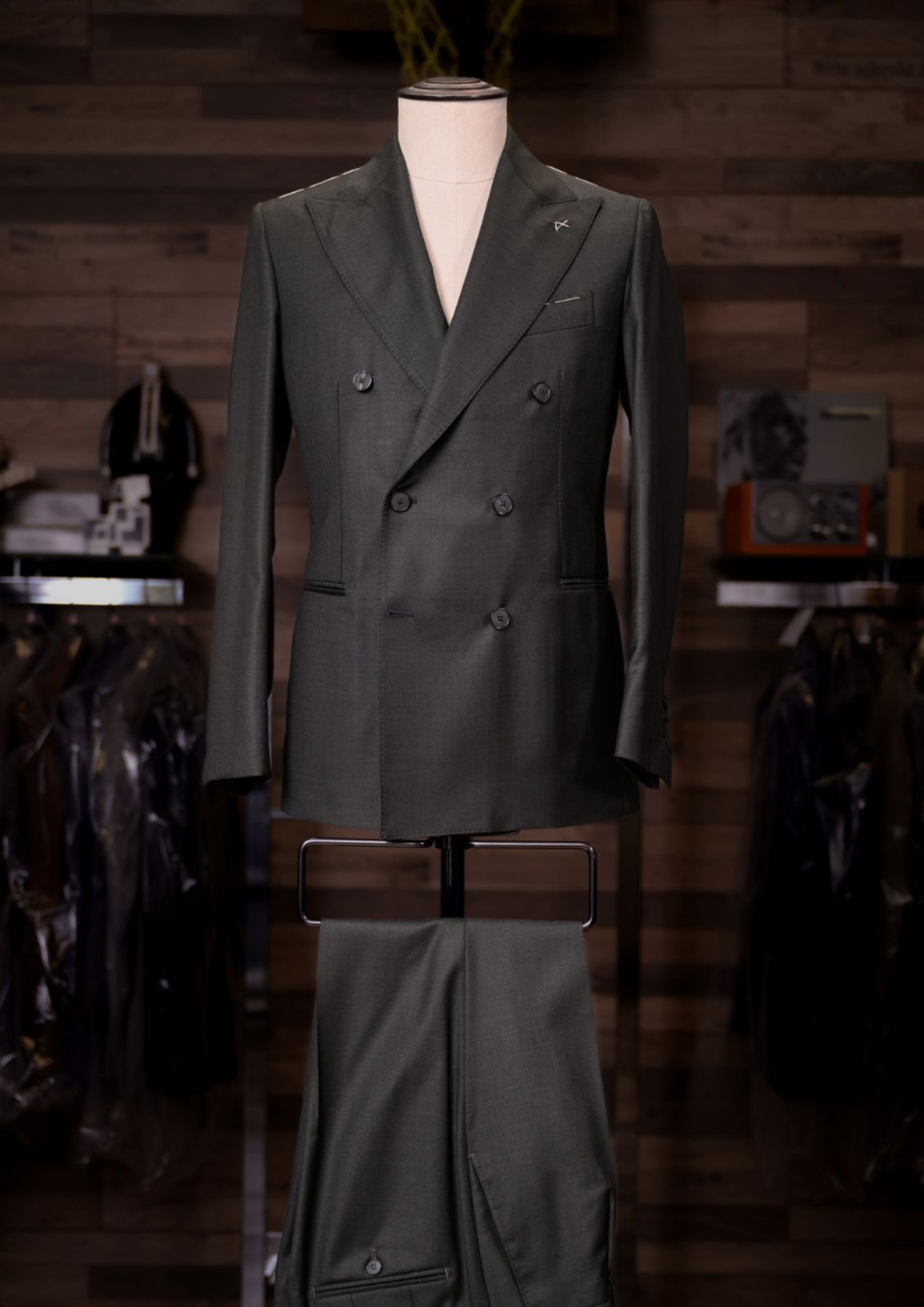 Olive green double-breasted Carelli suit on a tailor's mannequin
