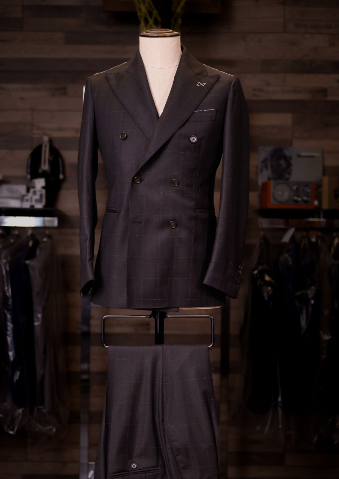 Espresso brown windowpane double-breasted Carelli suit on a tailor's mannequin
